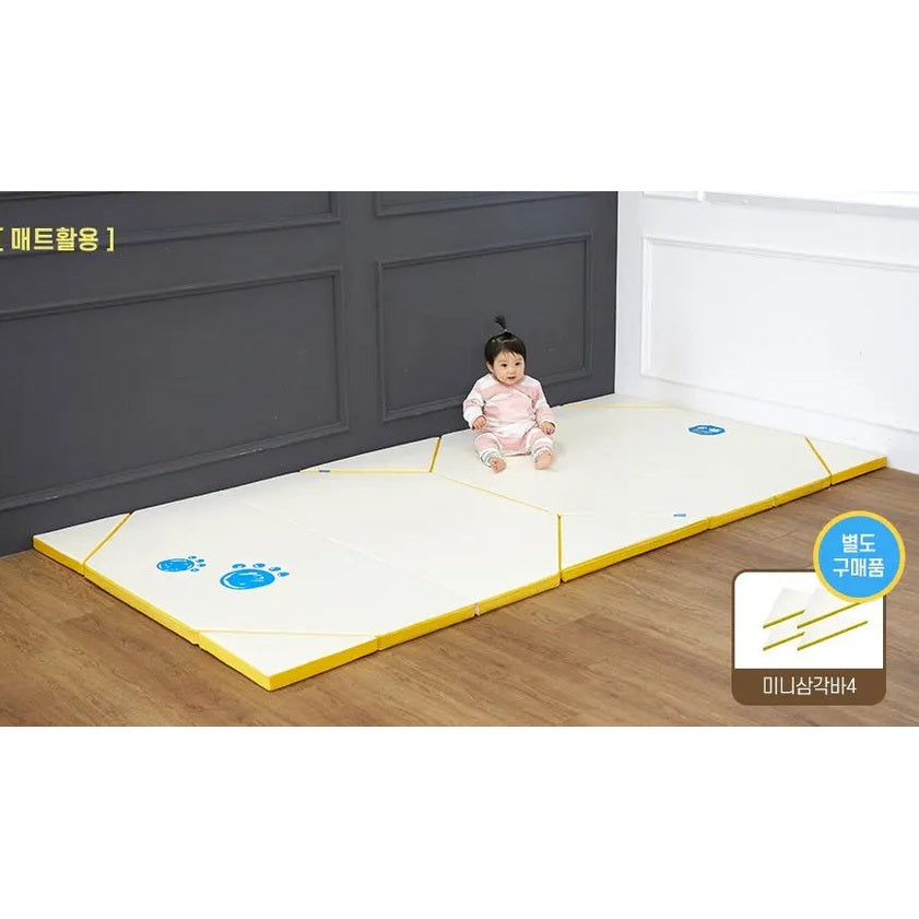 Creamhaus Grand Ice Castle Up Bt baby play mat set; cream foam tiles with yellow edges and blue footprints, baby sits safely.