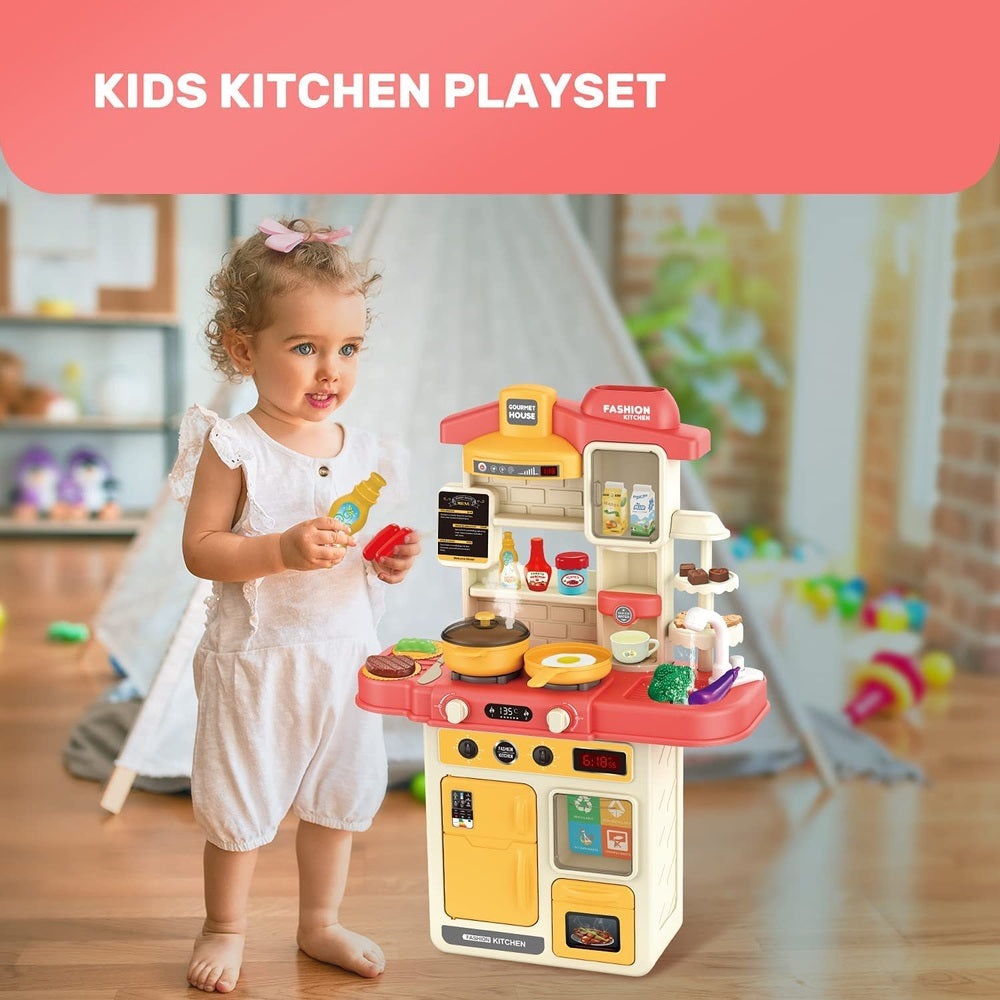 Cute Stone kids kitchen playset featuring red and yellow stove, accessories, and a child playing.