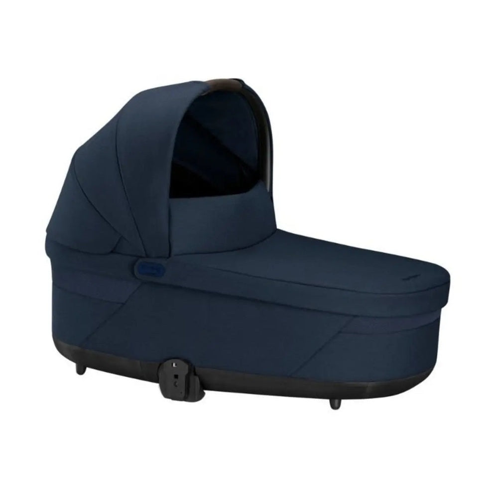 CYBEX Balios S Lux Cot navy blue bassinet with canopy, shown ready for baby transport in a sturdy chassis.