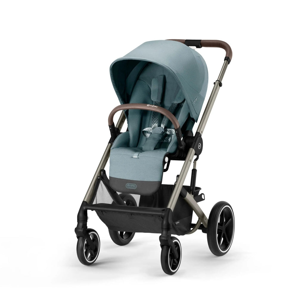Cybex Balios S Lux Stroller in teal with brown leatherette handle and large wheels, ready for a stroll.