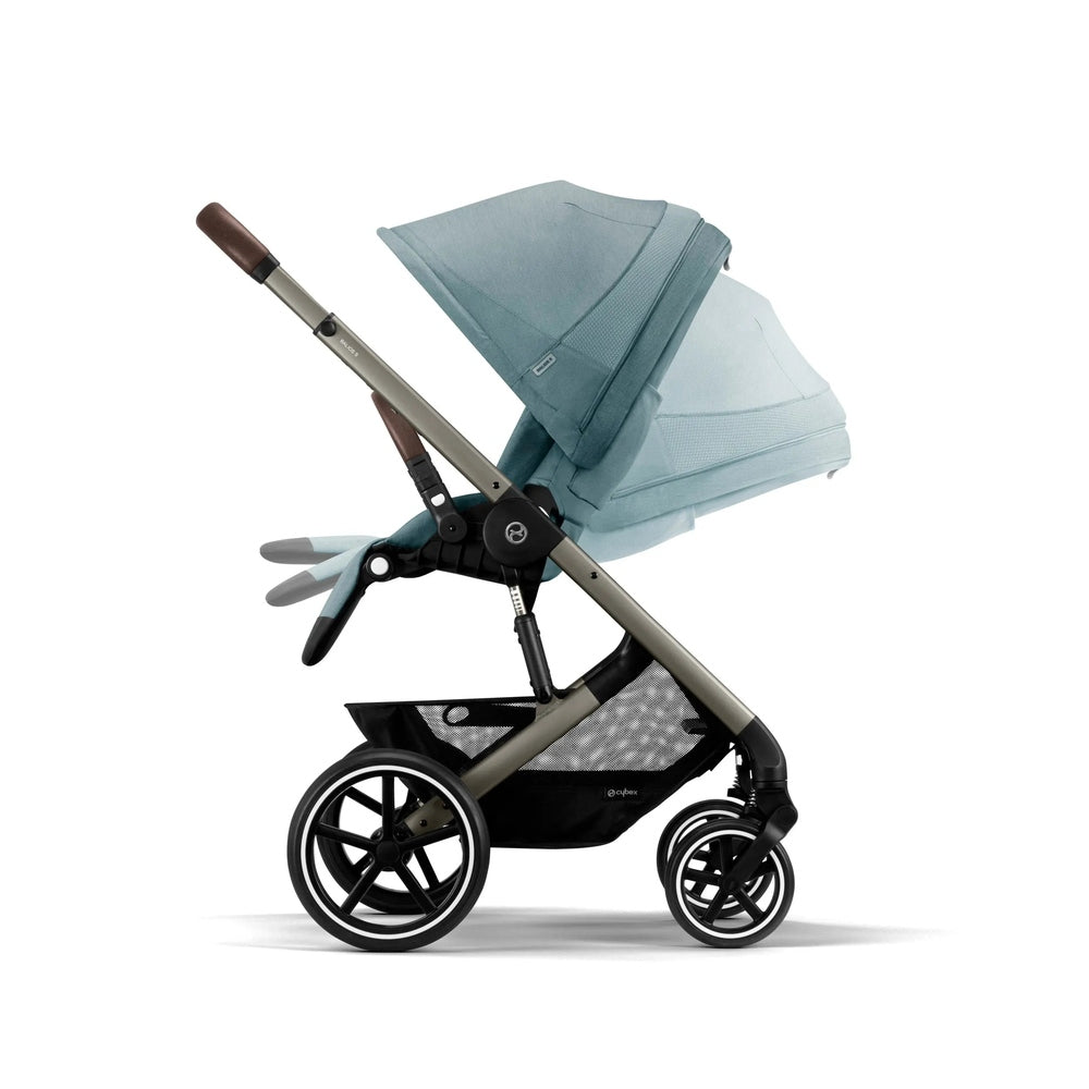 Cybex Balios S Lux Stroller in teal, with reclined seat and large wheels, showing underbasket storage