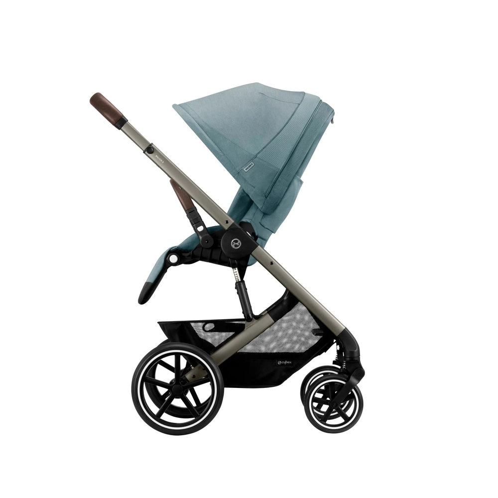 Cybex Balios S Lux Stroller in teal with extended canopy, brown-grip handle, and large wheels.