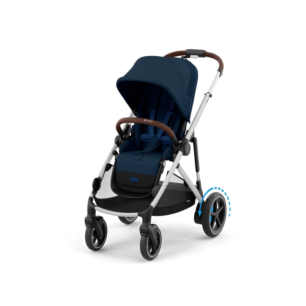 Cybex E-Gazelle S stroller in navy with brown leather handle and white frame, rear wheel turning for smooth maneuverability