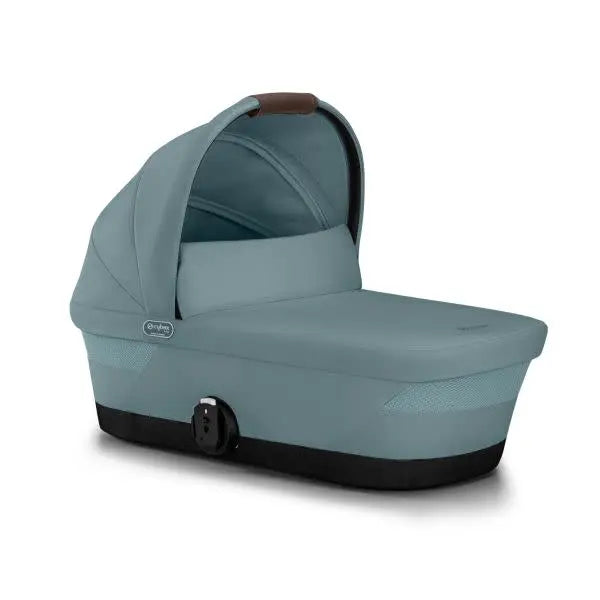 CYBEX Gazelle S V2 Cot bassinet in teal with canopy, shown with its elevated, ready-for-newborn bed.