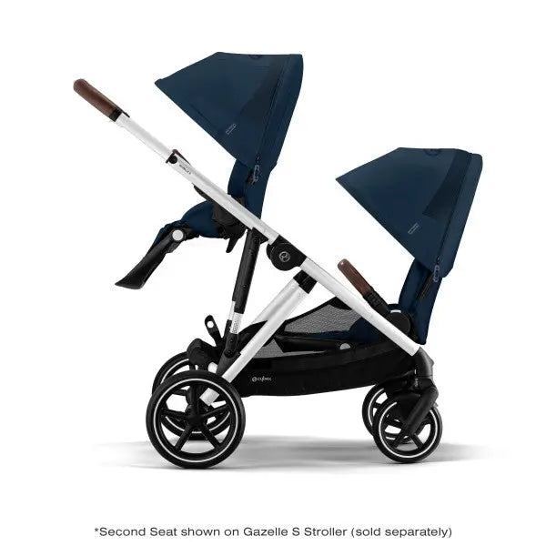 Cybex Gazelle S V2 Toddle Seat double stroller in navy; two seats extended, silver frame, brown handles.