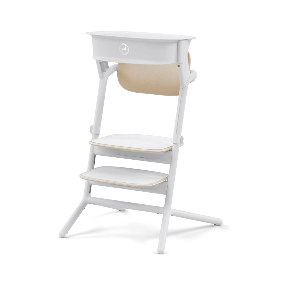 Cybex Lemo Training Tower high chair in white with light wood shelves, showing a sturdy frame and three steps.
