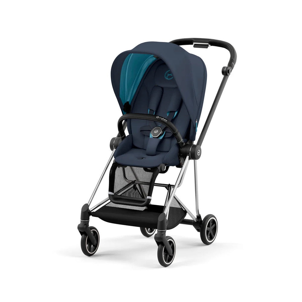 Cybex Mios 3 stroller in navy with teal canopy, padded seat, and mesh storage basket being pushed along.