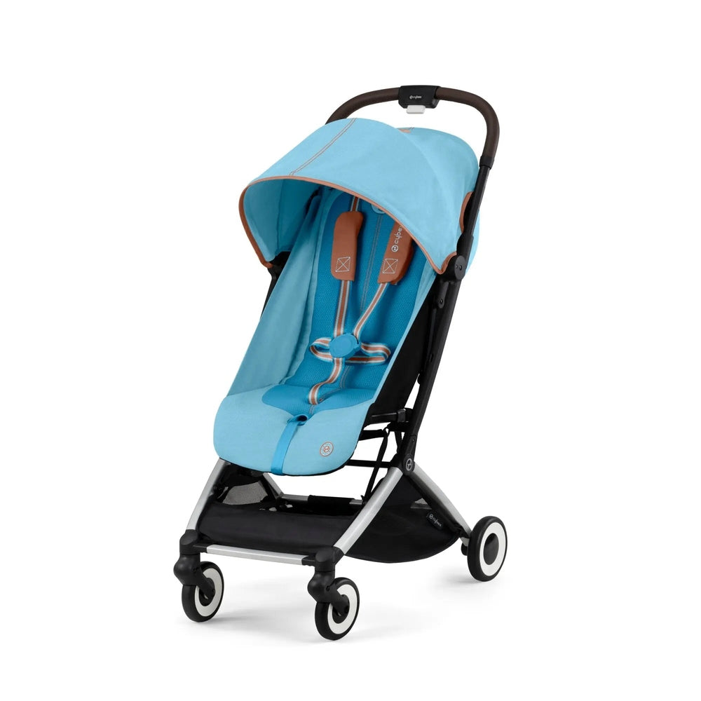 Cybex Orfeo stroller in light blue with brown trim, canopy extended for shade.