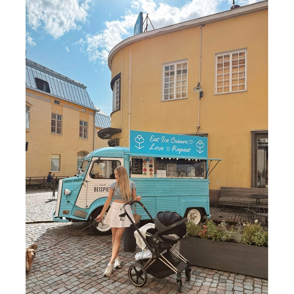 CYBEX Priam 4 Stroller with Lux Carry Cot in Sepia Black, on city street