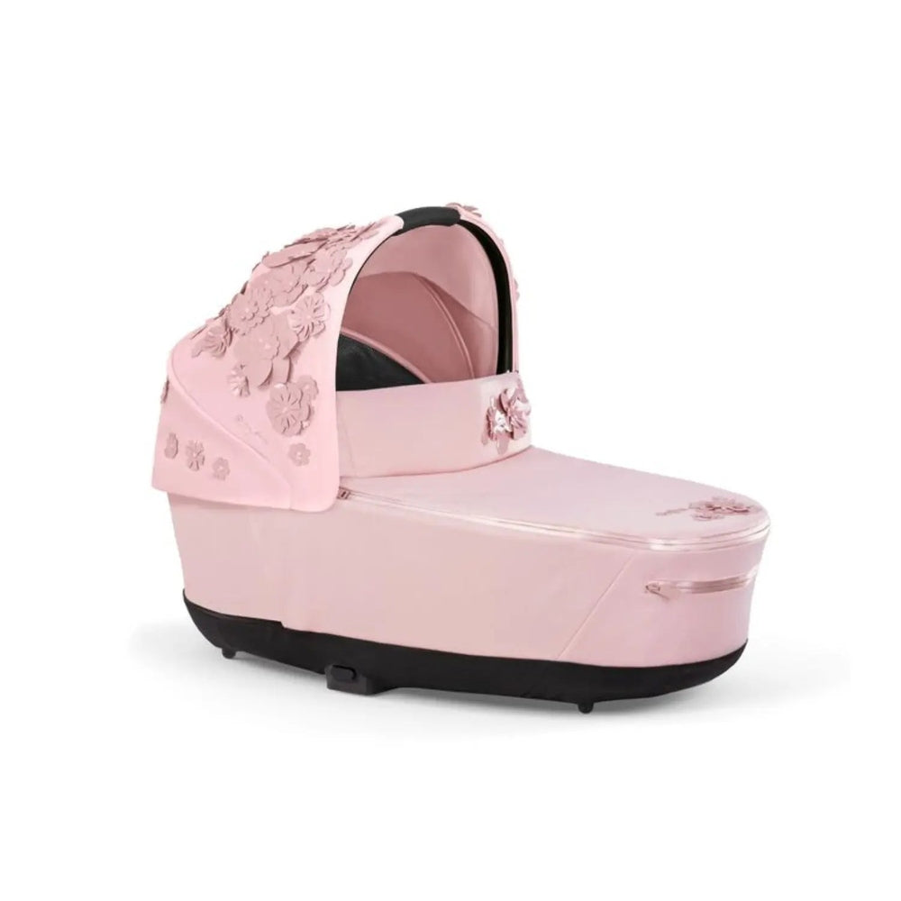 Cybex Priam Carry Cot Limited Edition pink floral canopy attached to stroller base for newborn transport.
