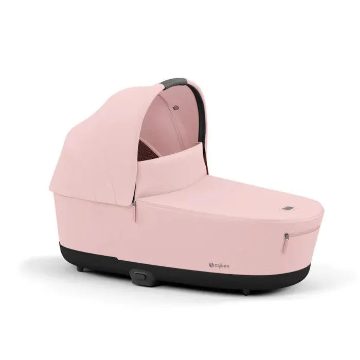Cybex Priam Lux Carry Cot in pink with black base and extended canopy, ready for newborn baby transport.