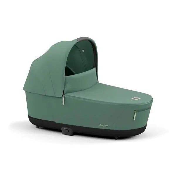 Cybex Priam Lux Carry Cot in green with extended canopy, cradle-style bassinet on stroller base.