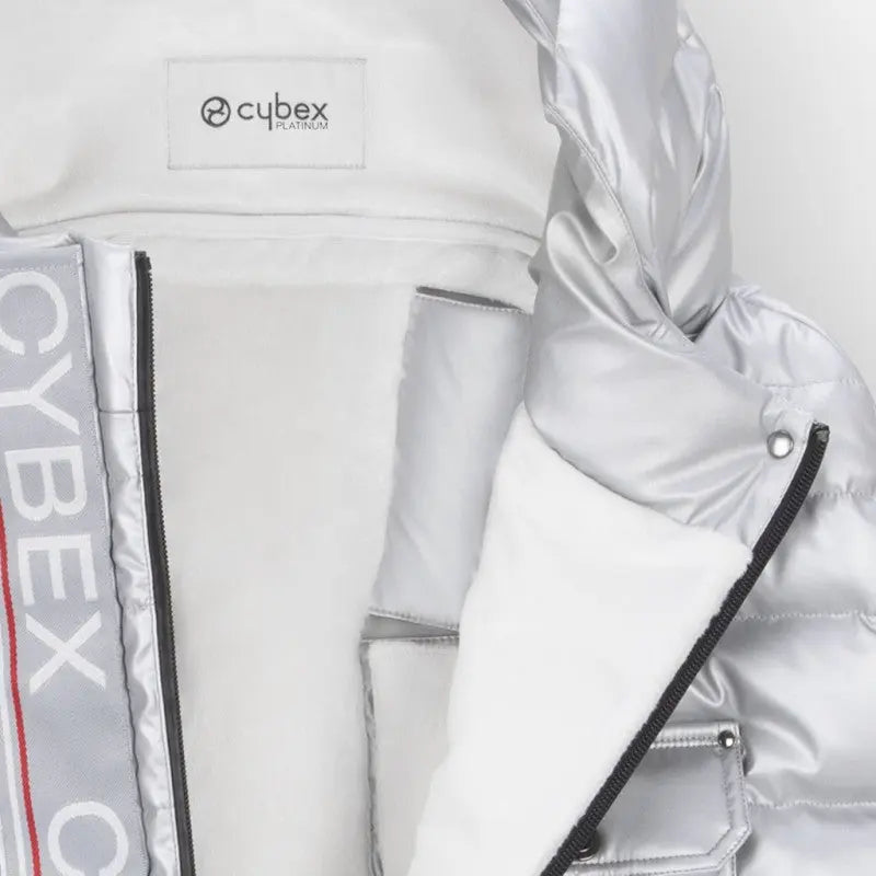 Cybex Winter Footmuff, white with soft fleece lining and black zipper, shown attached to a stroller.