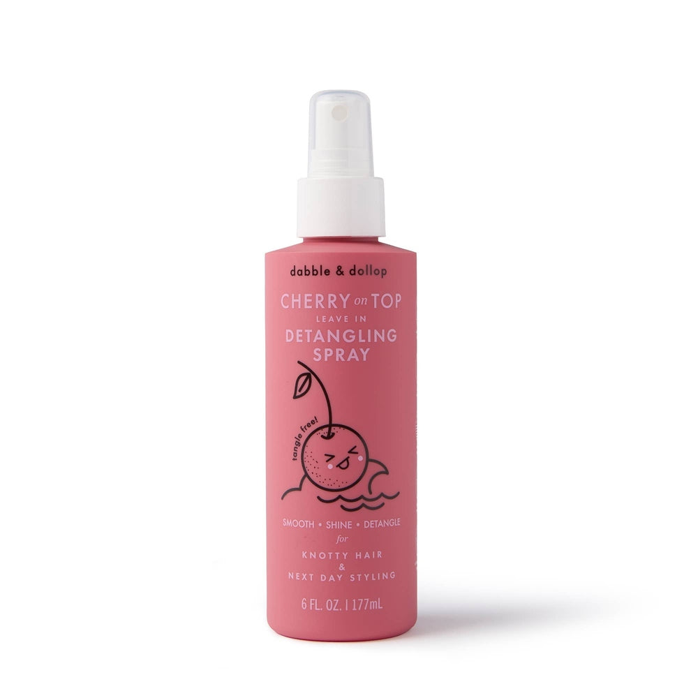 Dabble & Dollop Cherry on Top Detangling Spray in pink bottle with a spray nozzle ready to mist hair