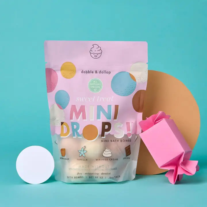 Dabble & Dollop Mini Drops Bath Bombs in Pink packaging with pastel multicolor circles on teal background