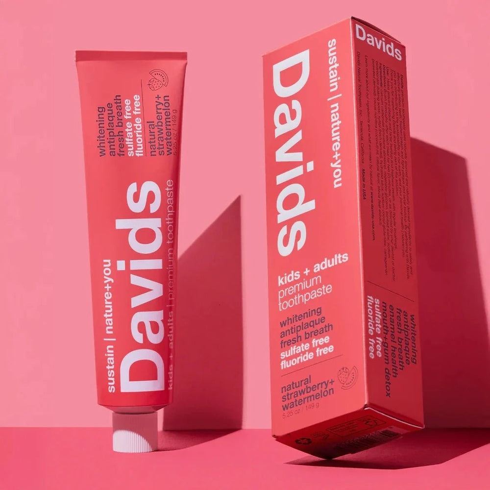 Davids toothpaste Fluoride-Free Strawberry Watermelon tube beside pink box, highlighting natural flavor.