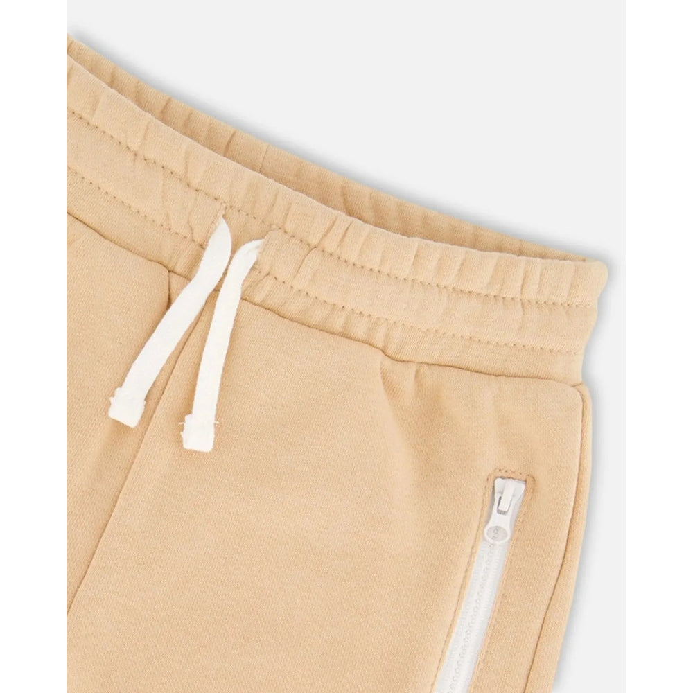 DeuxParDeux beige French Terry short with white drawstrings and side zip pocket.
