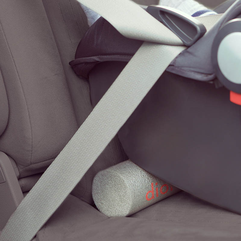 Diono Sit Rite grey car seat accessory with red logo, tucked under a car seat.