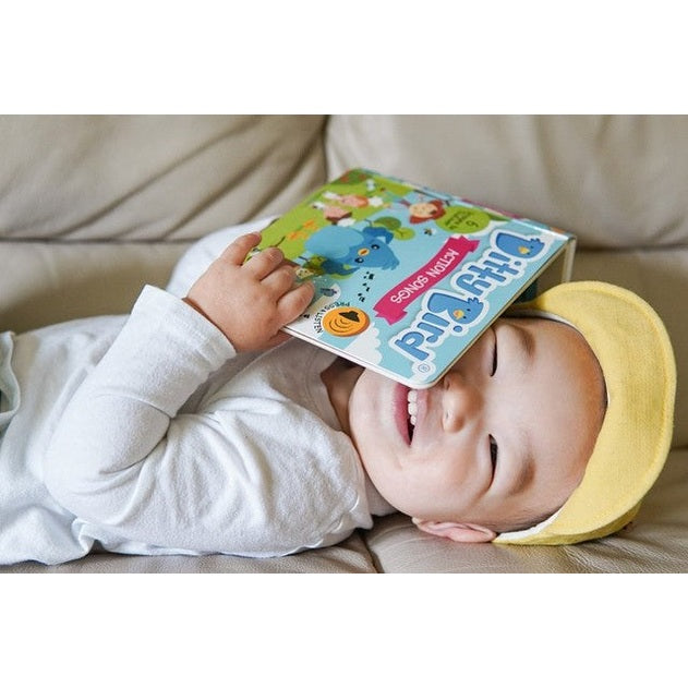 Ditty Bird Sound Book Action Songs USB-C Rechargeable; a smiling baby holds the colorful Ditty Bird book.