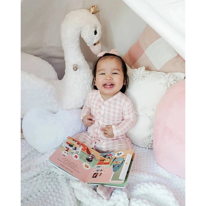 Ditty Bird Sound Book Animal Songs USB-C Rechargeable, smiling baby in pink plaid pajamas reads beside a plush swan.