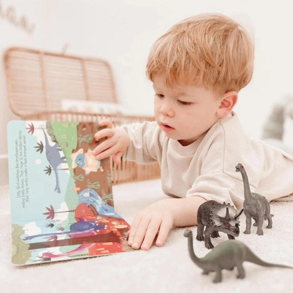 Ditty Bird Sound Book Dinosaur Sounds USB-C Rechargeable, read by toddler with dinosaur figures nearby.