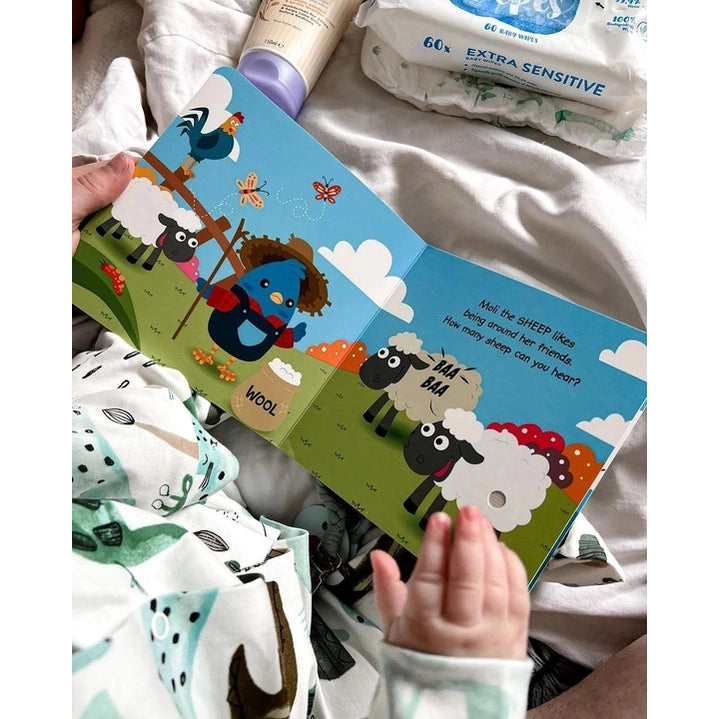 Ditty Bird Sound Book Farm Animal; a child turns pages through a bright farm scene illustration.