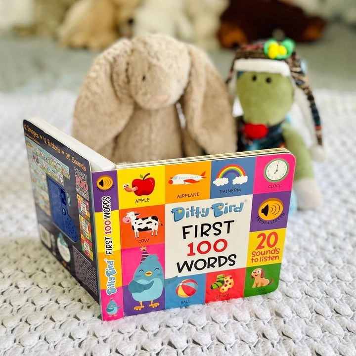 Ditty Bird First 100 Words USB-C Rechargeable toy book; colorful cover shows 20 sounds to listen as plush toys sit behind.