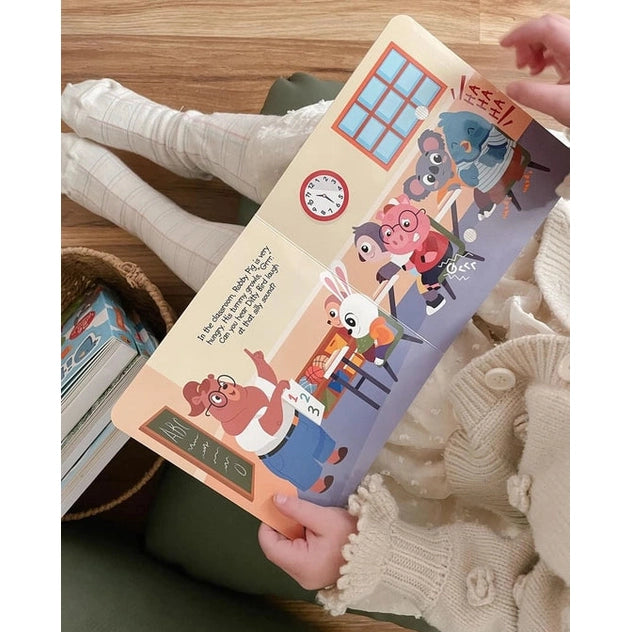 Ditty Bird Sound Book Funny Body Sounds USB-C Rechargeable; child holds a colorful classroom-page while reading.
