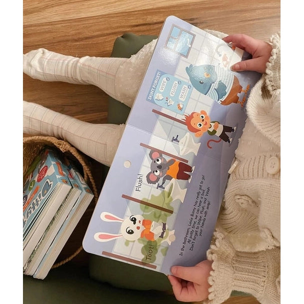 Ditty Bird Sound Book Funny Body Sounds USB-C Rechargeable, held by a child as it opens to animal-sound pages.