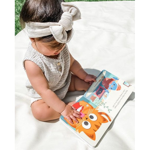 Ditty Bird Sound Book Touch The Cute Animals USB-C Rechargeable toy; baby taps colorful pages on a white blanket.