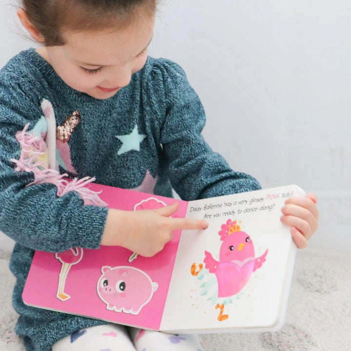 Ditty Bird Sound Book Touch the Colors USB-C Rechargeable; a girl points to a pink bird page.