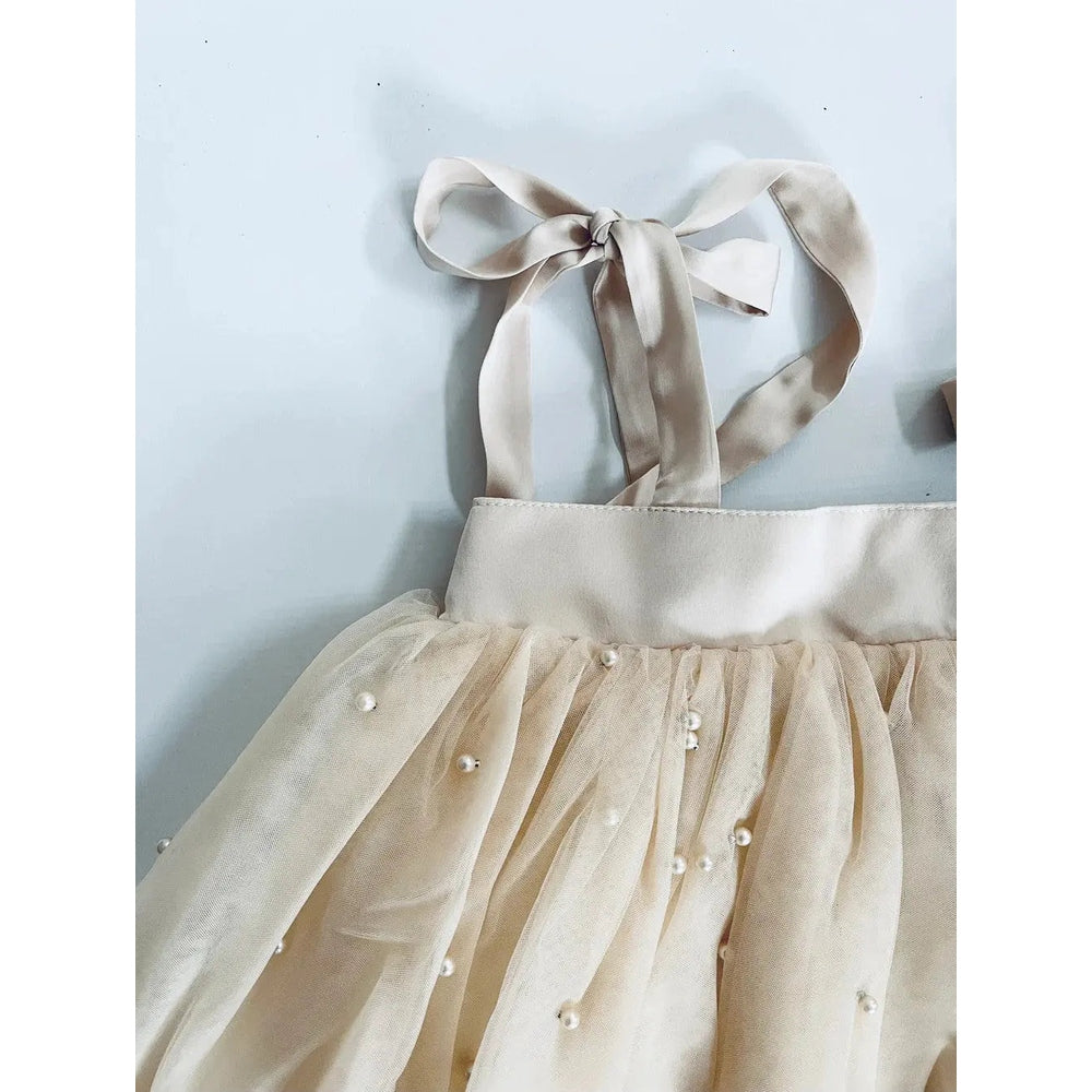 Dolly by Le Petit Pearl 2-Cute Tulle Dress Cream with satin bow straps tied at back and pearl bead accents.