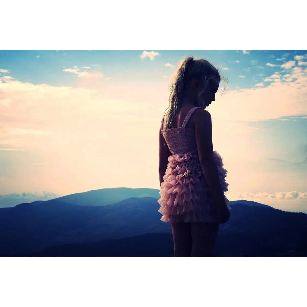 Dolly By Le Petit Tom Frilly Pants Tutu Bloomer Mauve worn by a girl standing silhouette against sunset mountains
