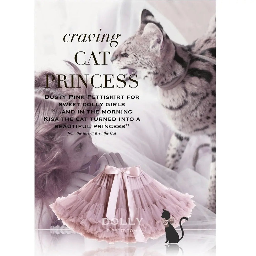 Dolly By Le Petit Tom Pettiskirt Cat Princess in dusty pink; a voluminous, ruffled tutu tied with a satin bow on display.