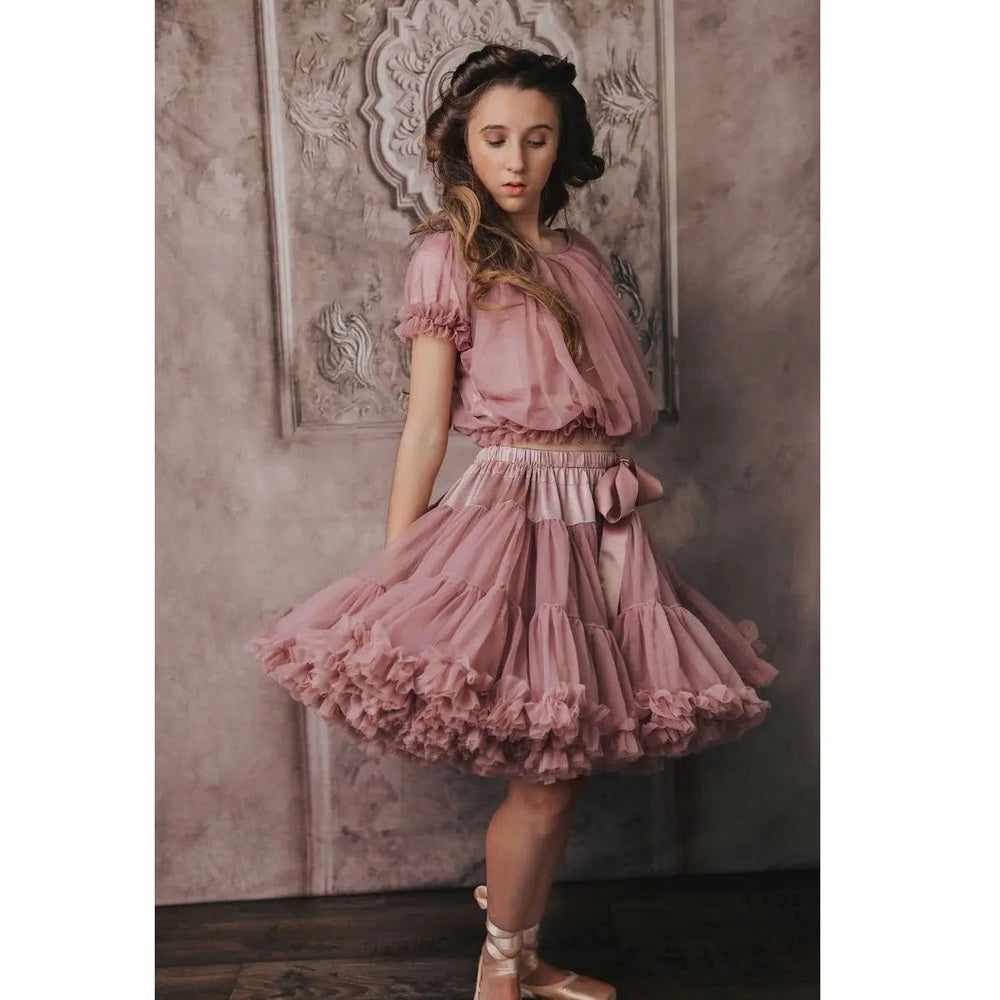 Dolly By Le Petit Tom Thumbelina Mauve Pettiskirt: a girl twirls in pink tulle with layered ruffles and bow.