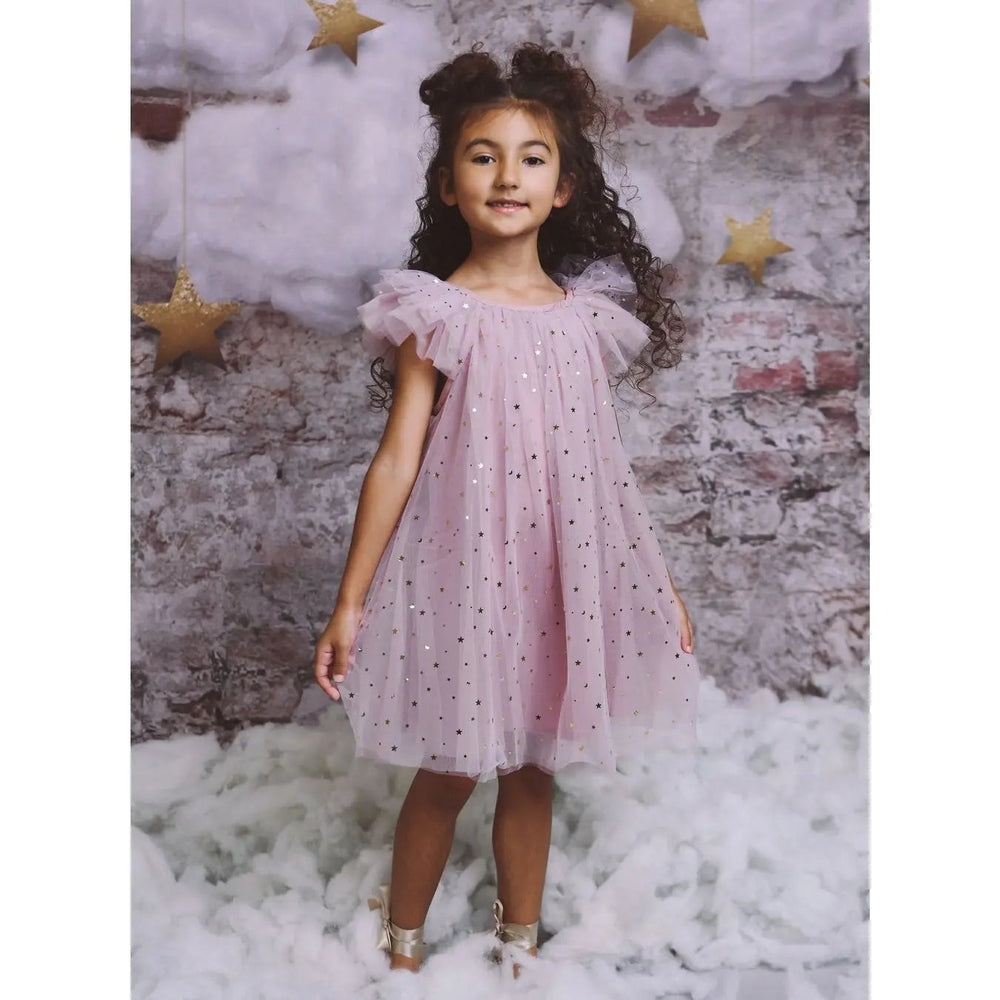 Dolly By Le Petit Tom Stars & Moon Tulle Fairy Dress in dusty violet; girl twirls showcasing starry tulle.