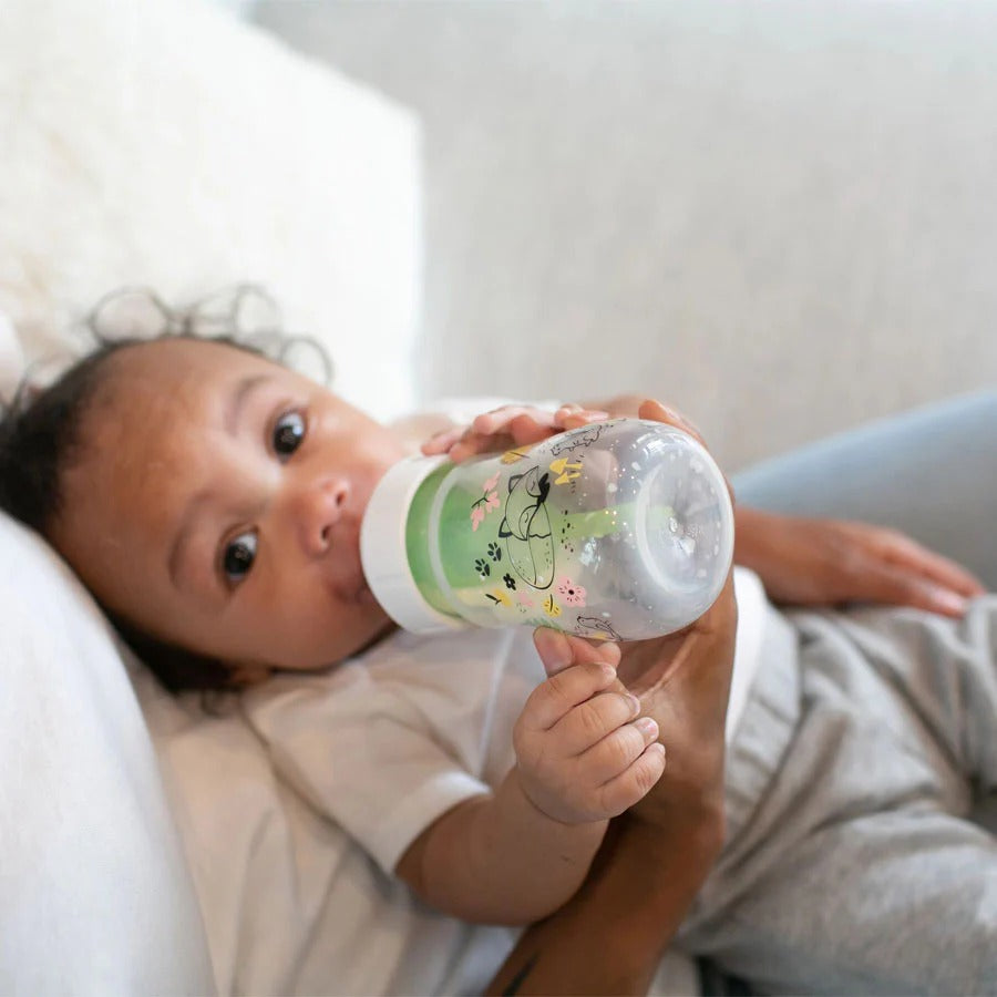 Baby feeding with a Dr. Brown's wide-neck anti-colic bottle featuring an internal vent system