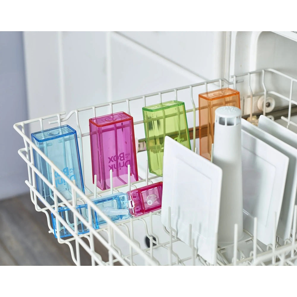 Drink In The Box water bottles in blue, pink, green and orange standing upright in a dishwasher rack.