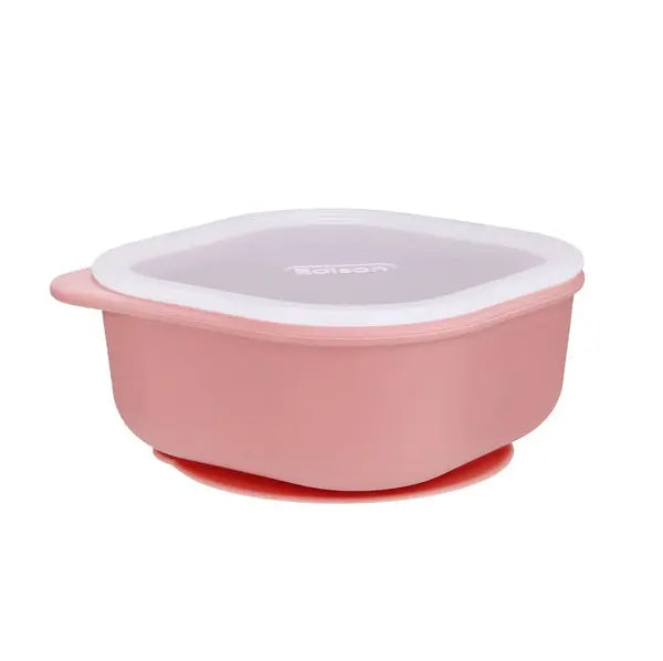 Edison Silicone Suction Bowl, pink with white rim and purple lid, securely attached to the table by its red suction base.