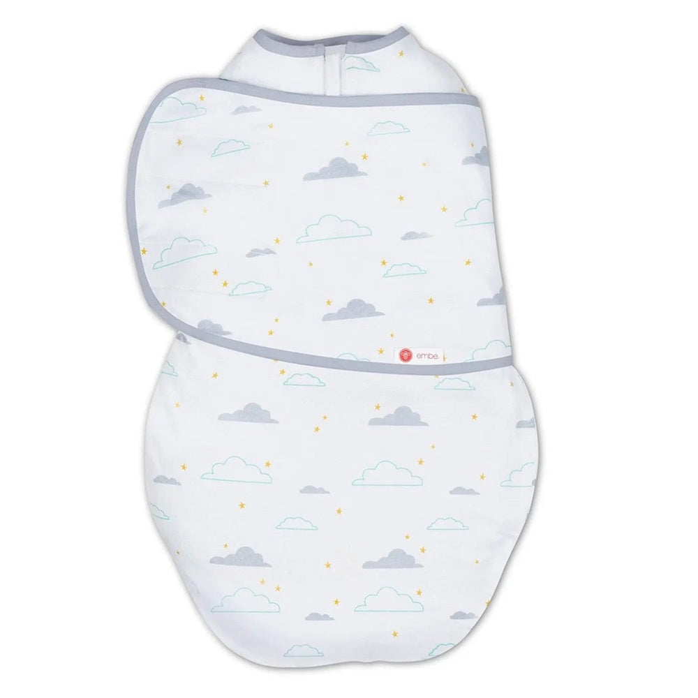 Embe Transitional Swaddleout blanket in white with gray-blue trim, cloud print, laid flat ready to wrap baby.