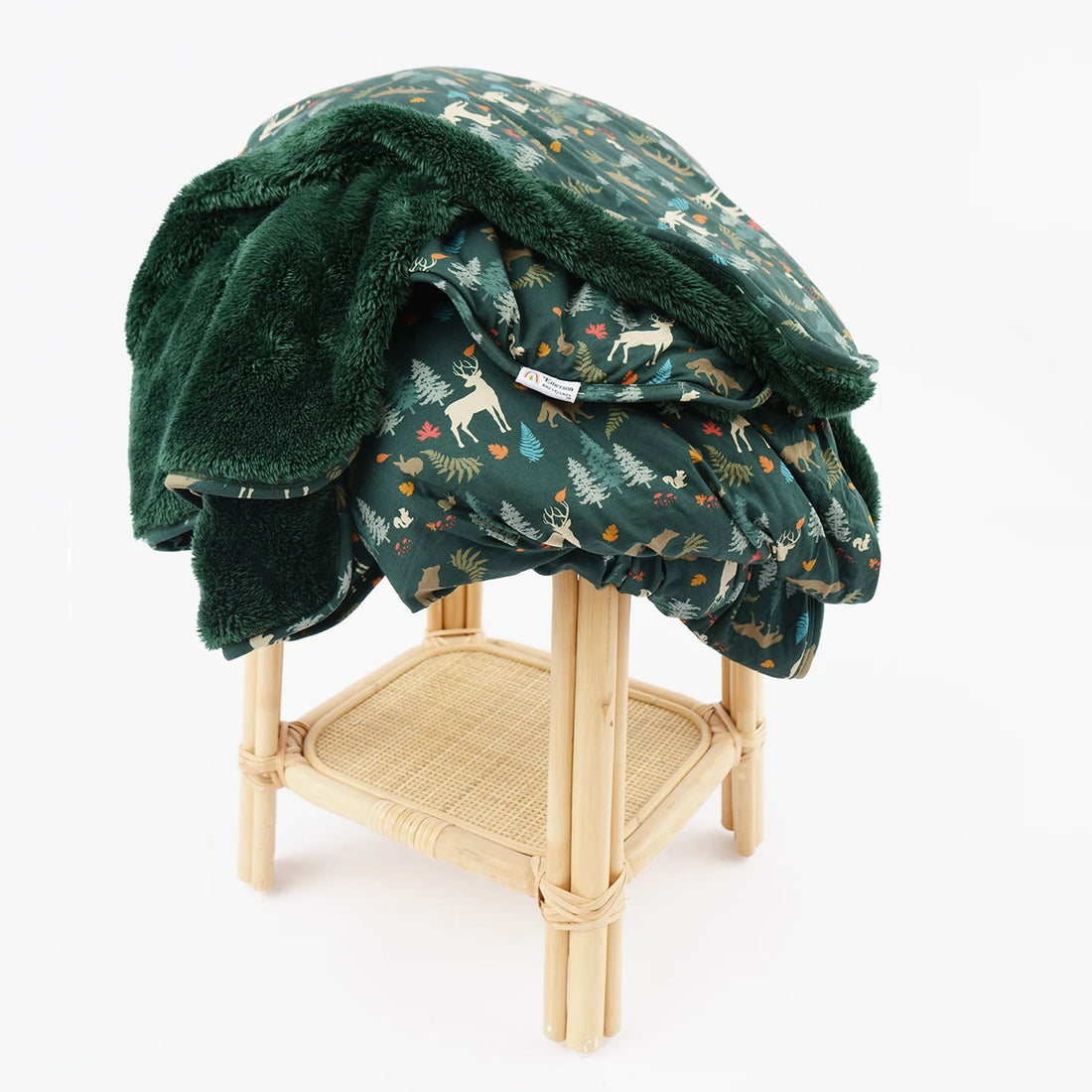 Midnight Forest twin bamboo and fleece blanket draped over a wooden stool