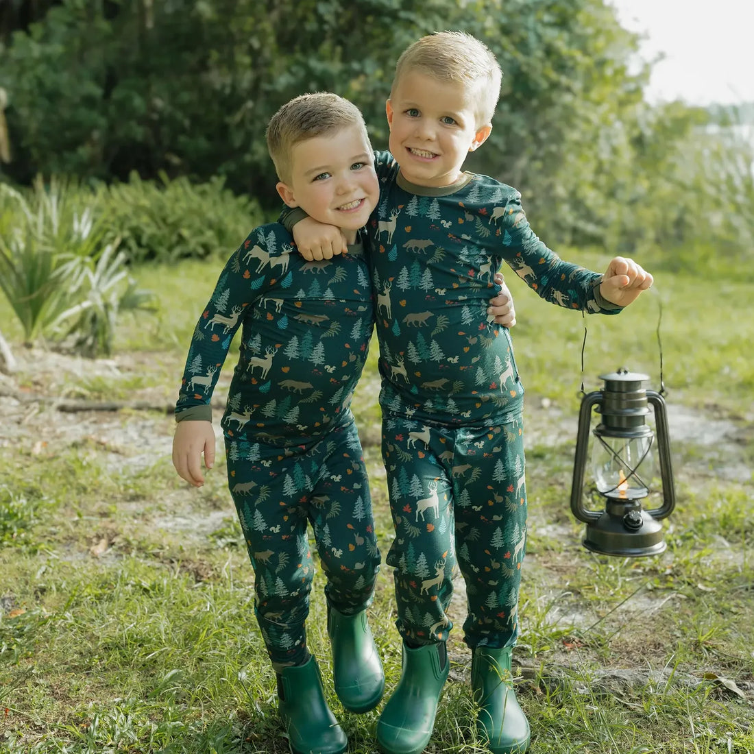 Two children wearing Midnight Forest bamboo pajamas outdoors
