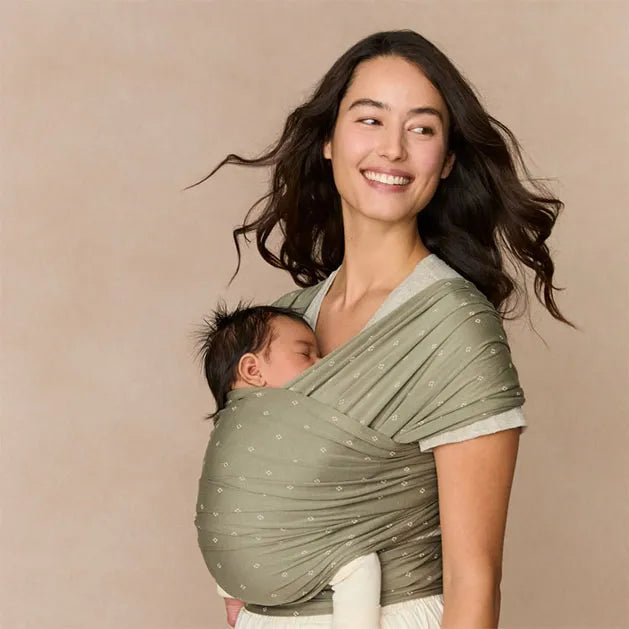 ERGOBABY Aura baby wrap in sage green knit carrying a sleeping infant