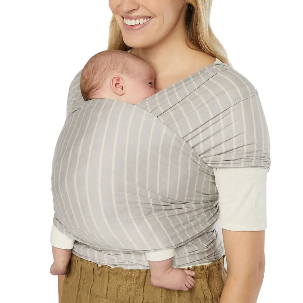 ERGOBABY Aura Baby Wrap in grey striped sustainable knit worn by mom with infant