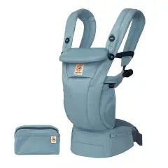 Ergobaby Omni Breeze baby carrier in blue-gray worn on a model, featuring breathable panels and a matching pouch.