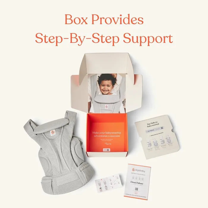 Ergobaby Omni Deluxe Carrier Mesh in gray; open box shows a baby wearing the carrier with instruction cards.