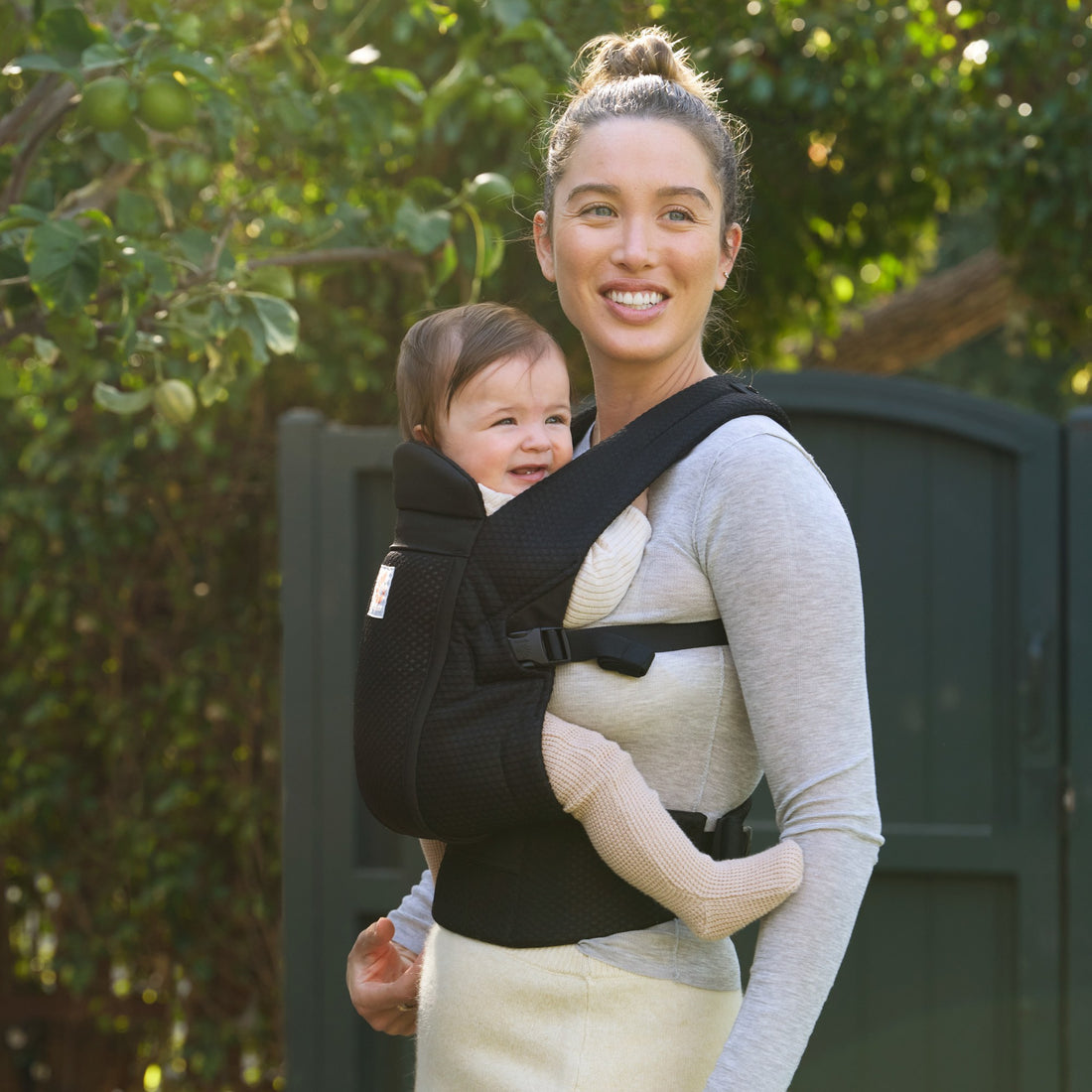 Ergobaby Omni Lite Baby Carrier in Onyx Black, lifestyle view with caregiver and baby