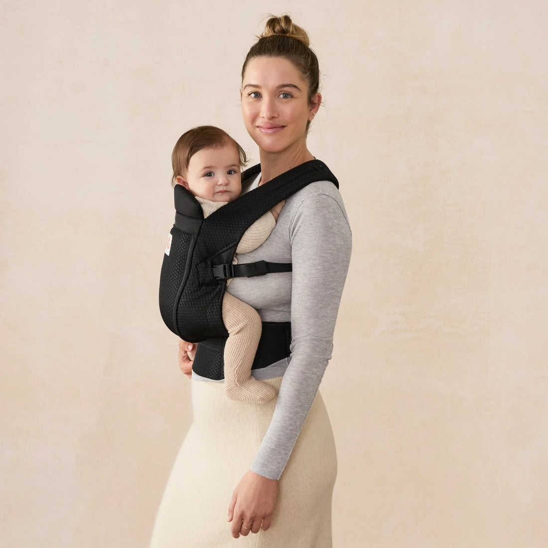 Ergobaby Omni Lite Baby Carrier in Onyx Black, side view worn with baby
