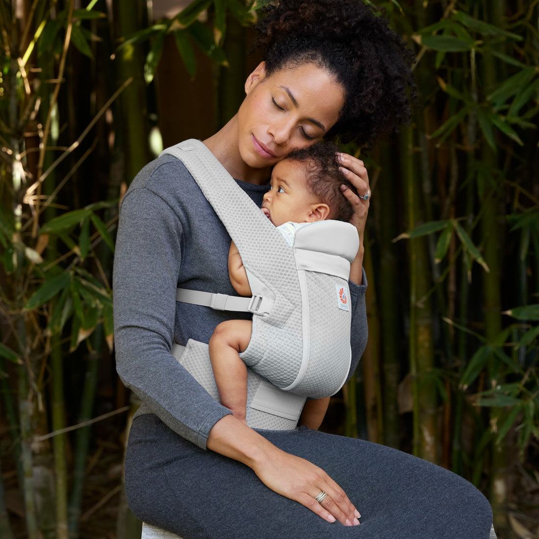 Ergobaby Omni Lite Baby Carrier in Pearl Grey, in-use lifestyle view with caregiver and baby