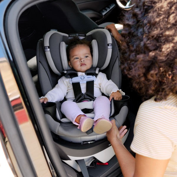 Evenflo Revolve360 Slim 2-in-1 rotational car seat with SensorSafe; infant secured in gray/black seat